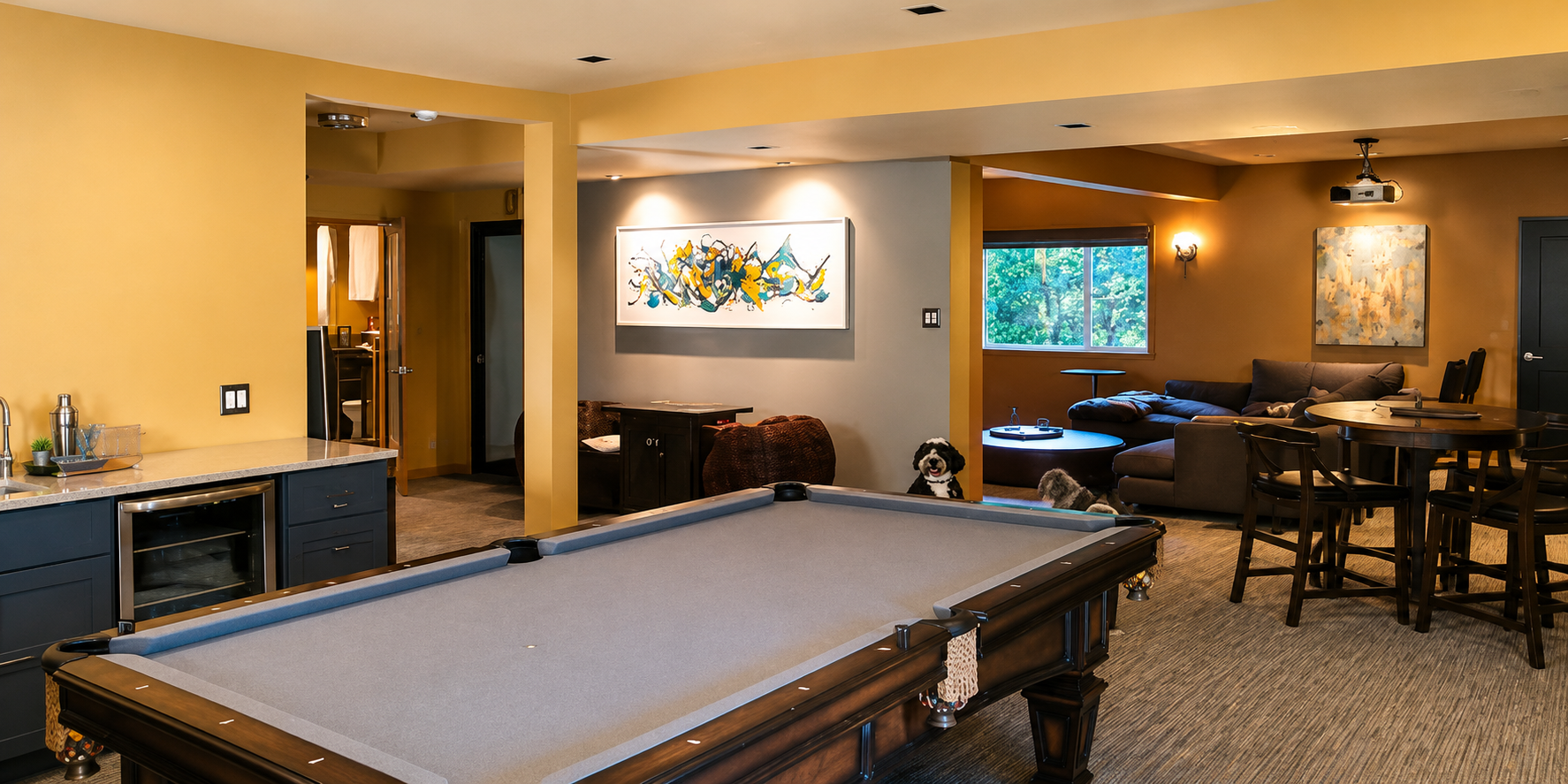 A dining table with white chairs sits in the foreground, leading to an open-plan kitchen and a living area with a fireplace.