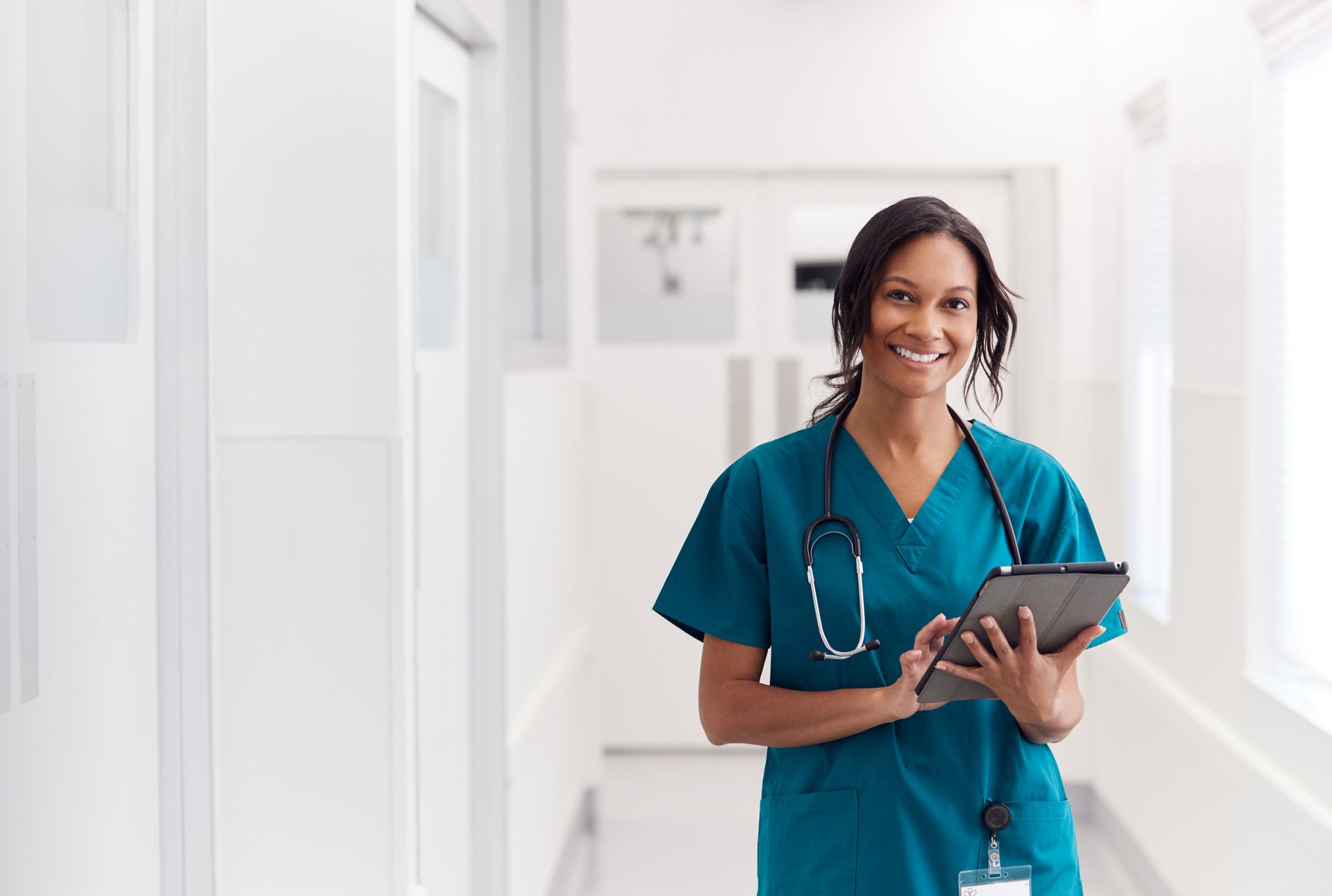 Nurse Walking While Holding a Dextrose Stand Nurse Walking While Holding a Dextrose Stand