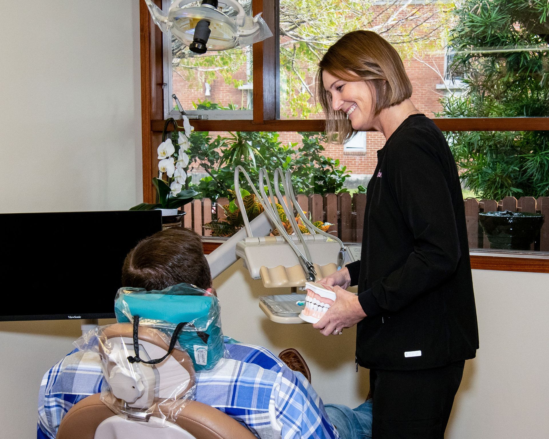 Top dentist speaking to dental patient | dental implants Corpus Christi TX