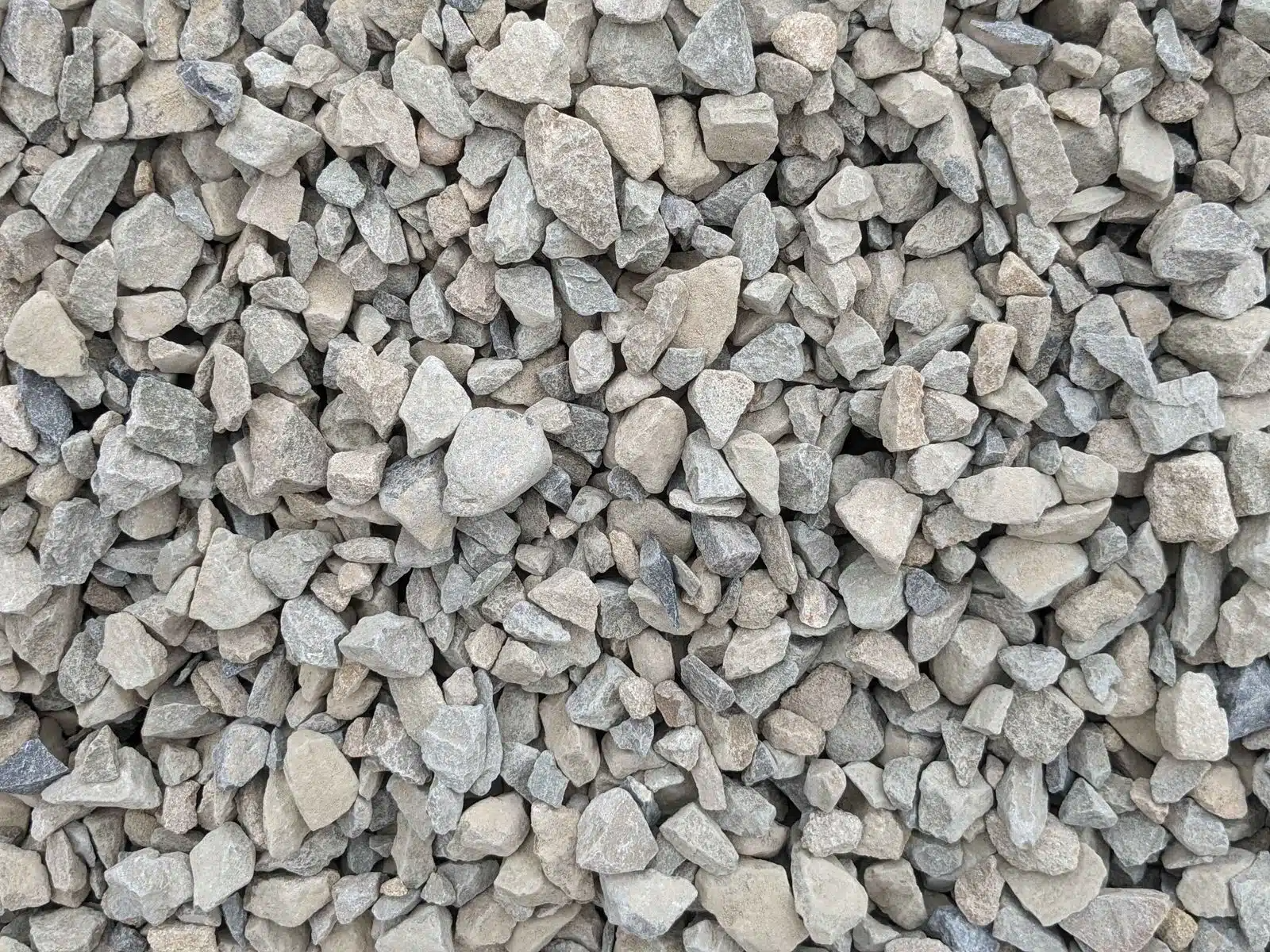 Pile of small gray crushed stones or gravel filling the frame
