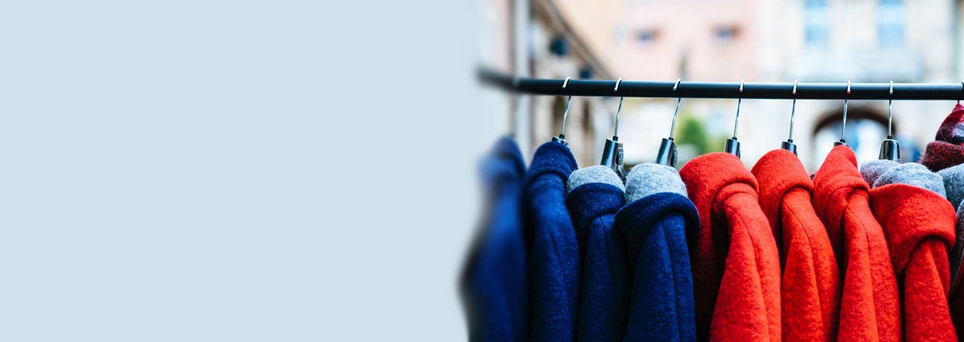 A bunch of clothes are hanging on a rack.