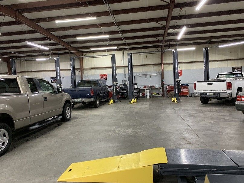 A lot of trucks are parked in a garage.