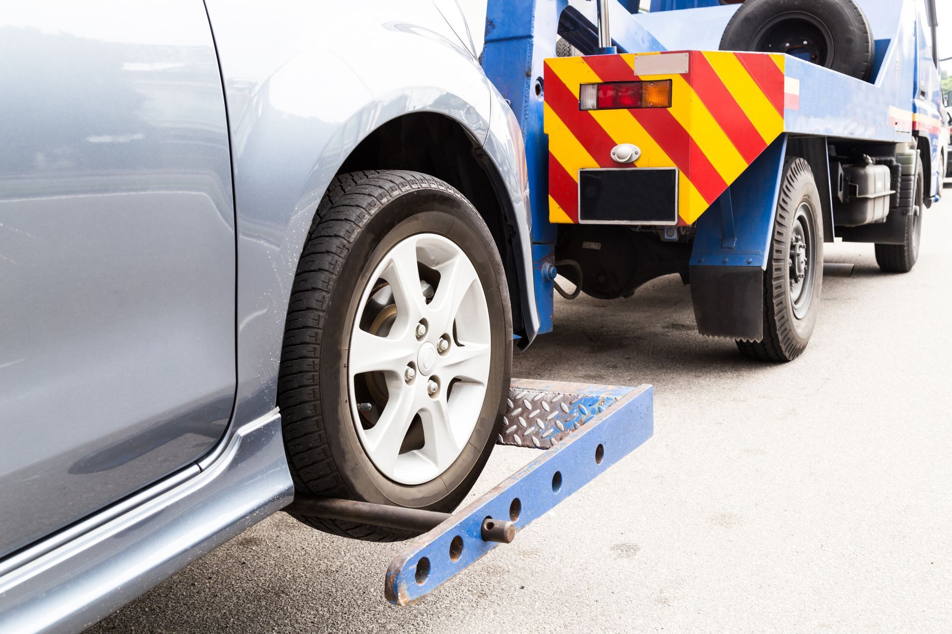 A Car Is Being Towed by A Tow Truck.