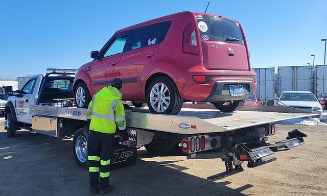 D & D 24 Hr Carrying Red Car At The Back - Appleton, WI - D & D 24 Hr Towing Inc