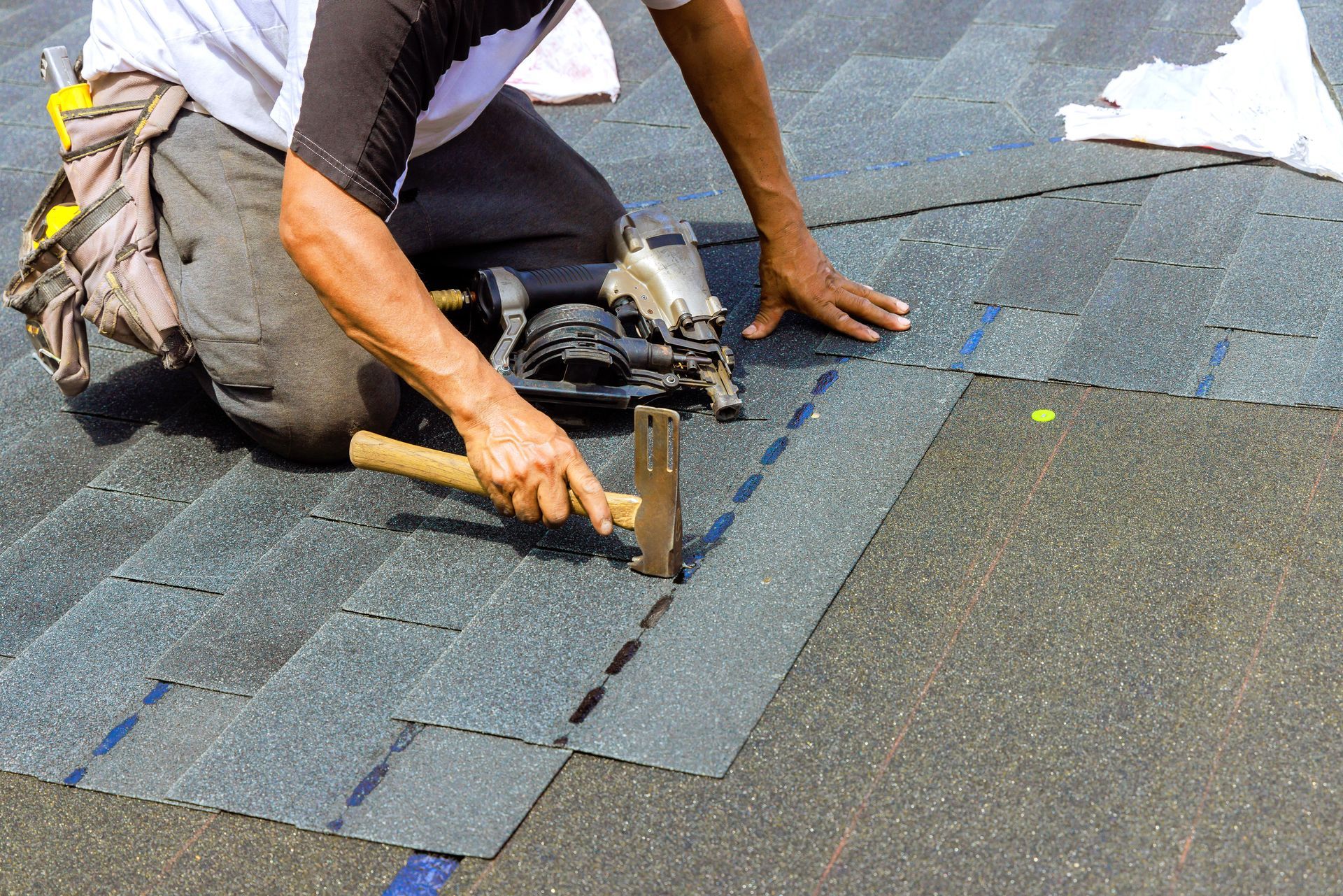 Roofer adding new roofing material