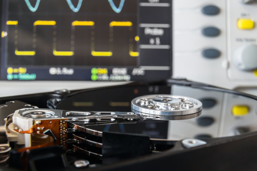 Hard Drive With Read/write Head, Oscilloscope Displaying a Square Wave — Tech Aid In Moffat Beach, QLD