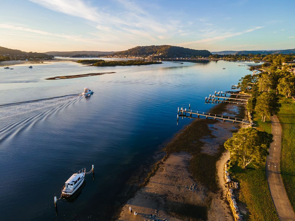 An Aerial View Of A River With A Boat In The Water — ASAP Pest Control in Brisbane South, QLD