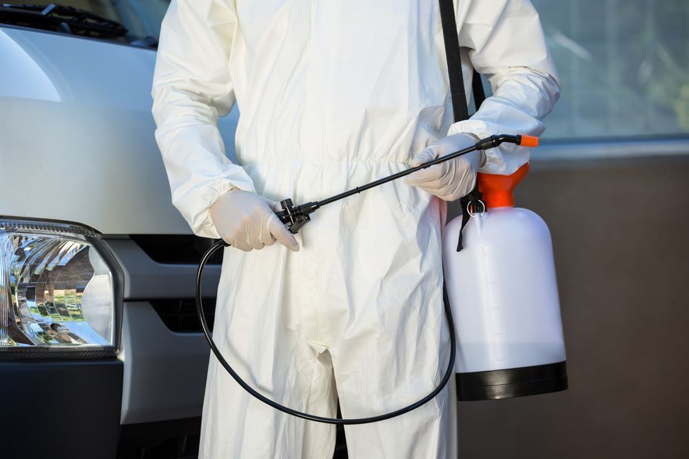 Mid Section Of Pest Control Man Standing Next To A Van On A Street — ASAP Pest Control In Bundamba, QLD