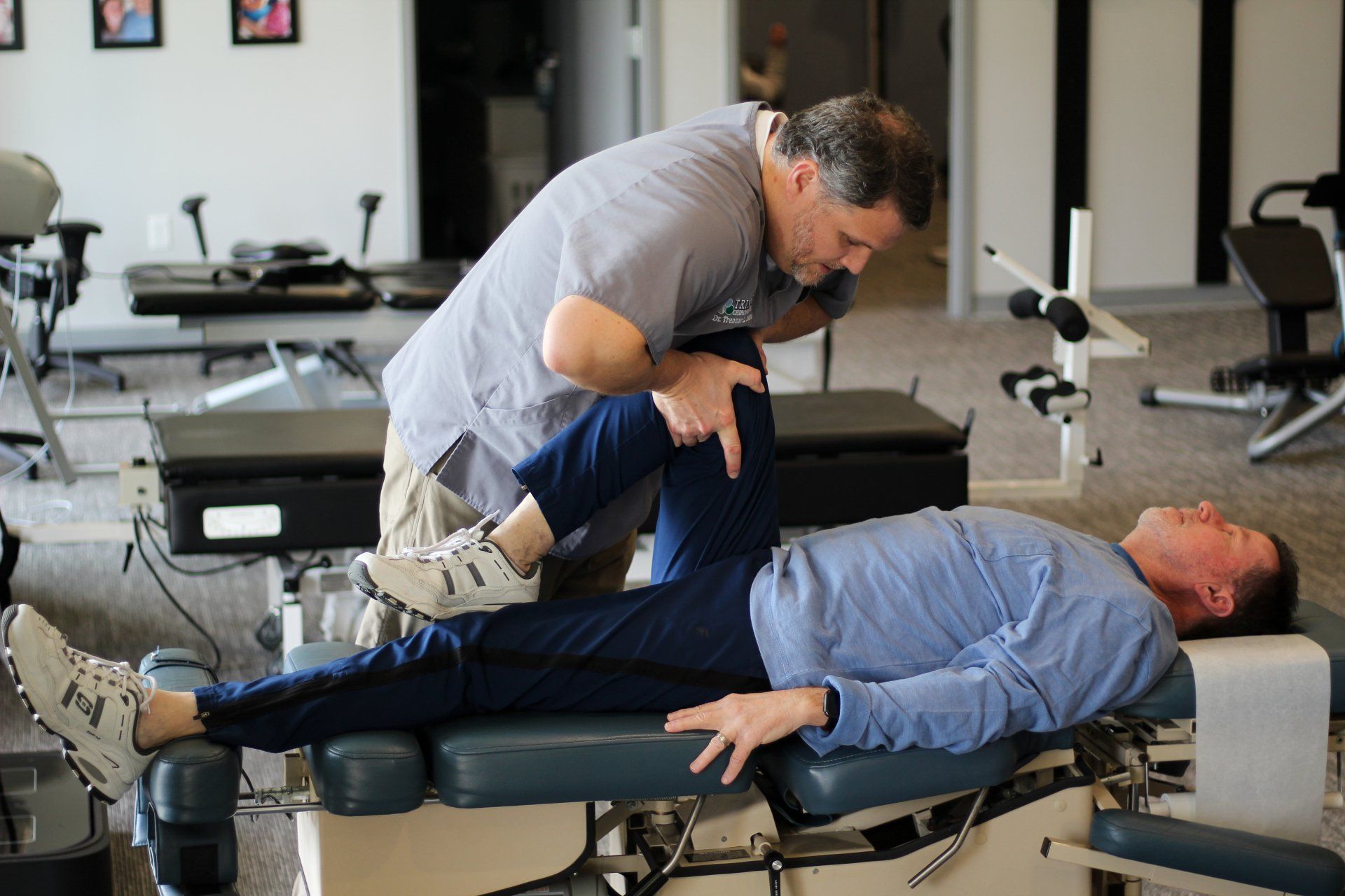 chiropractor adjusting the knee of a man