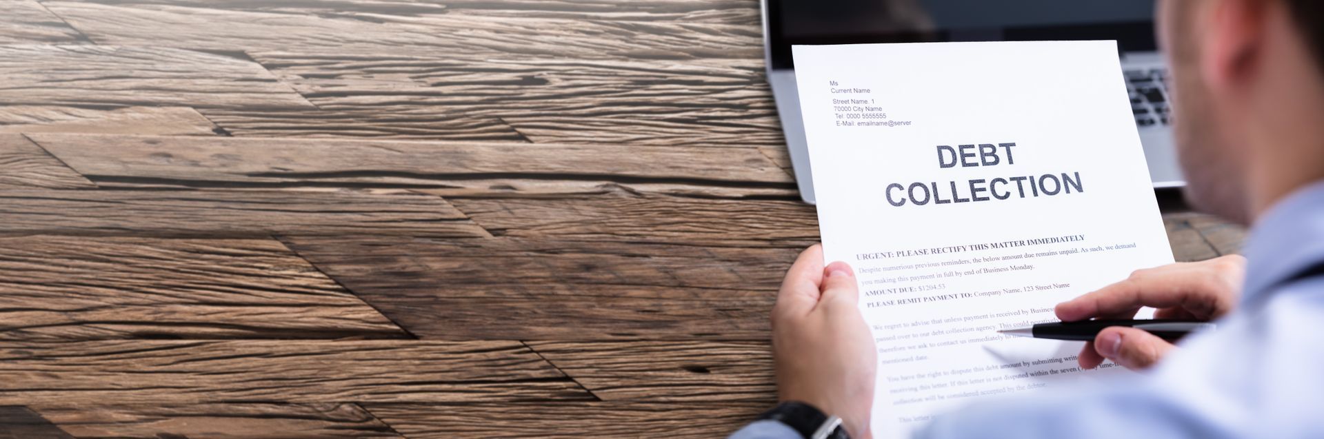 Experienced debt collector reviewing legal paperwork for debt collection. Experienced debt collector reviewing legal paperwork for debt collection.