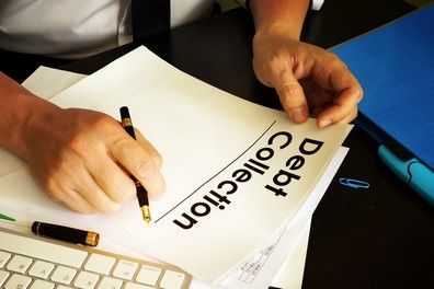 Hands signing a document labeled 