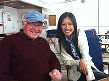 A man and a woman are sitting next to each other on a boat.