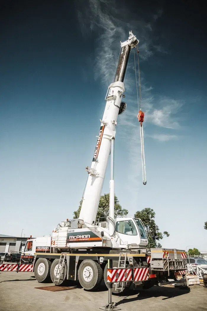 An Orange Crane with Its Shadow on a White Background  — Wyong, Nsw — Mcphan Cranes & Transport