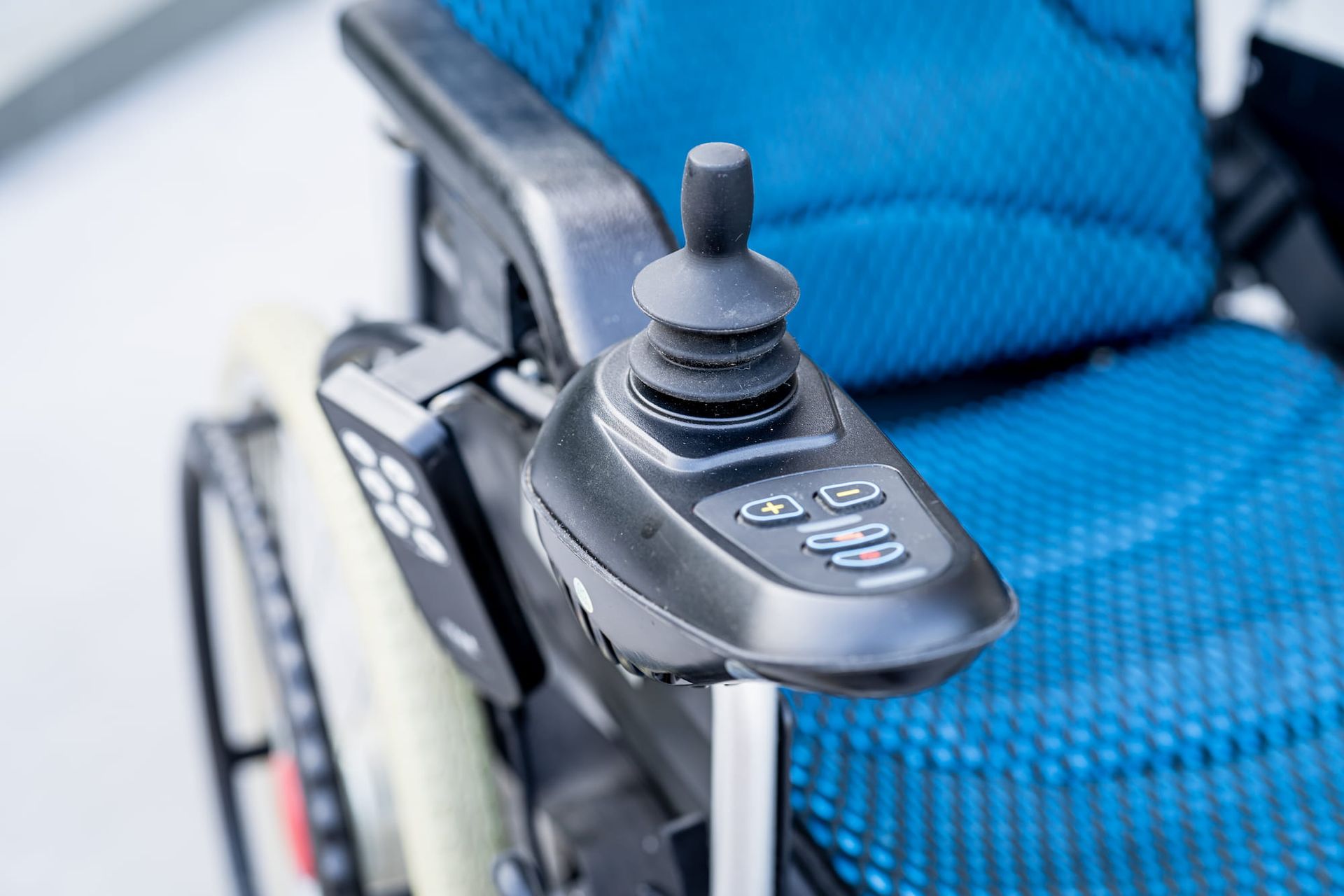 A close up of a remote control on a wheelchair.
