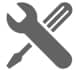 a wrench and screwdriver crossed over each other on a white background .