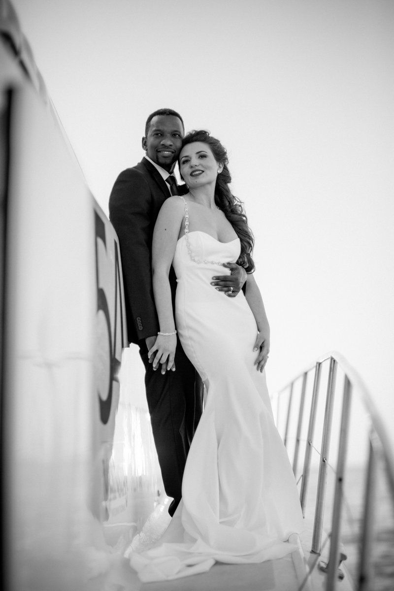 A black and white photo of a bride and groom posing for a picture.