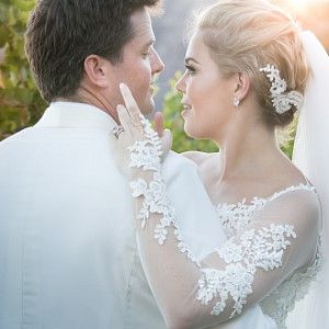 A bride and groom are looking into each other 's eyes on their wedding day.