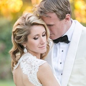 A bride and groom are posing for a picture on their wedding day.