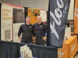 Two men at a trade show booth promoting 