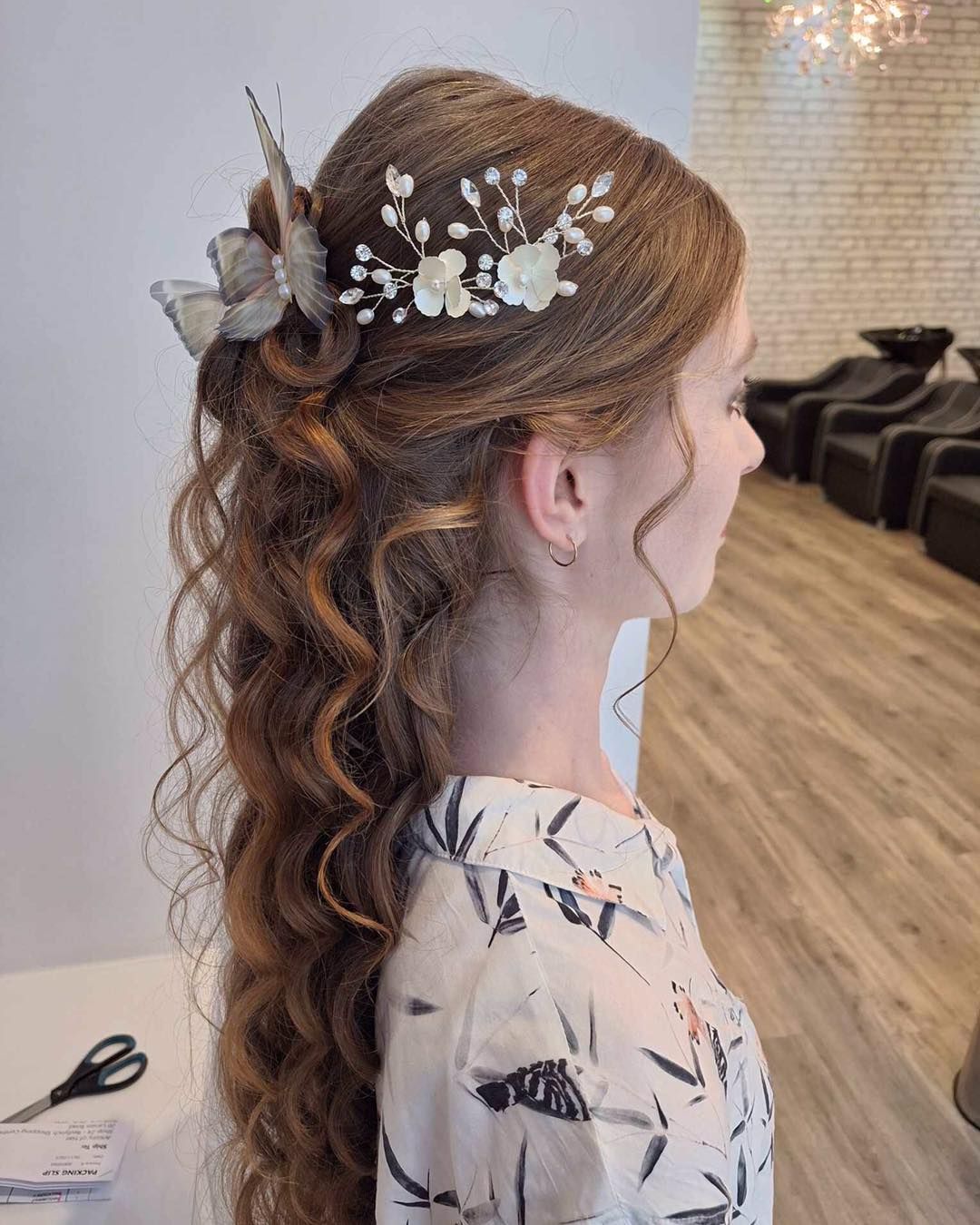 Woman With Long, Curly Auburn Hair, Styled With Butterfly Hair Accessories — Artistry Of Hair in Redlynch, QLD