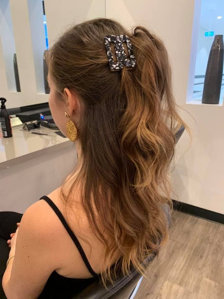 Woman With Brown Hair in a Salon Chair, Styled Half-up With a Patterned Claw Clip — Artistry Of Hair in Redlynch, QLD