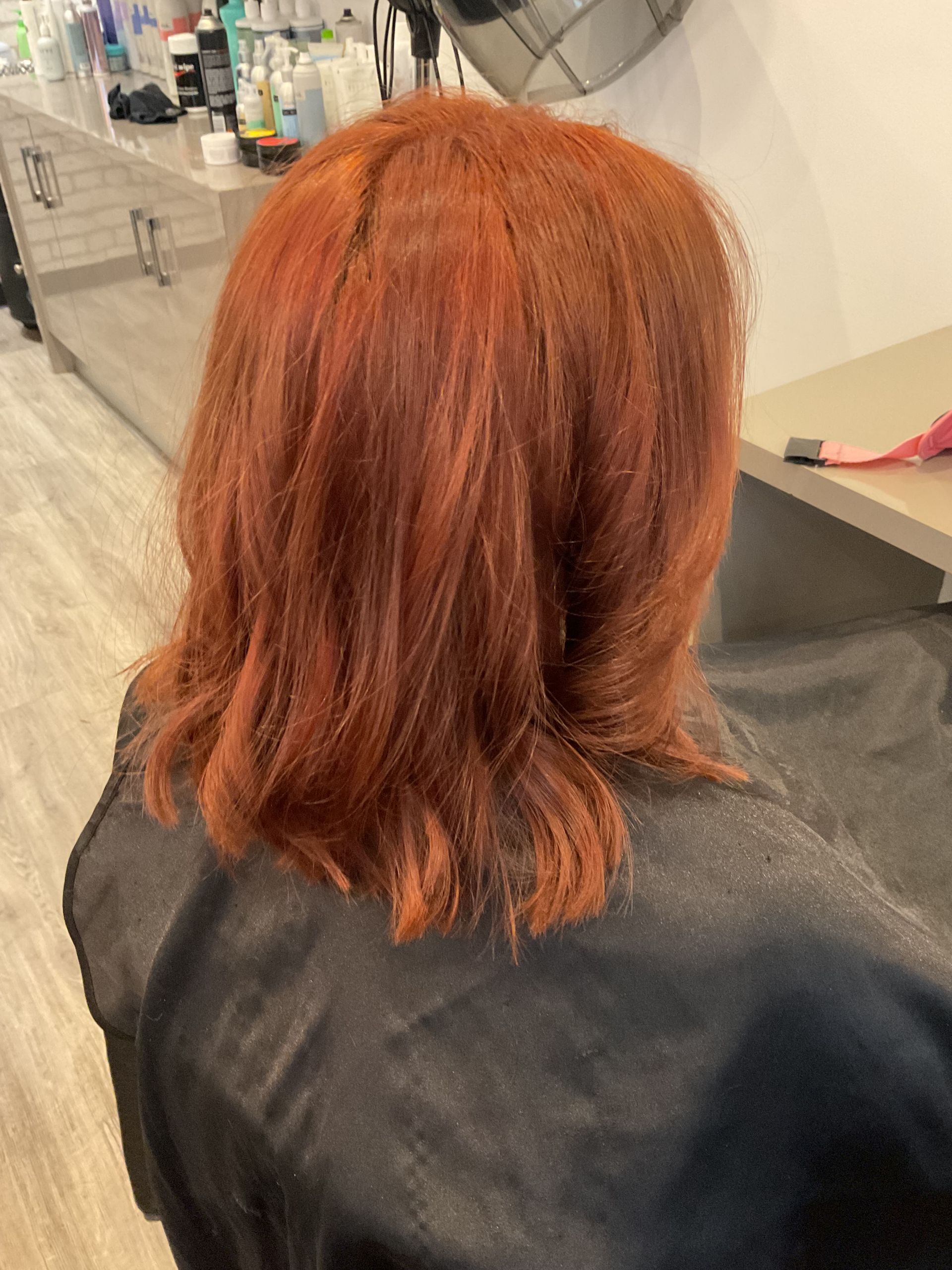 Woman in Salon Chair With Layered Blonde Hair — Artistry Of Hair in Redlynch, QLD