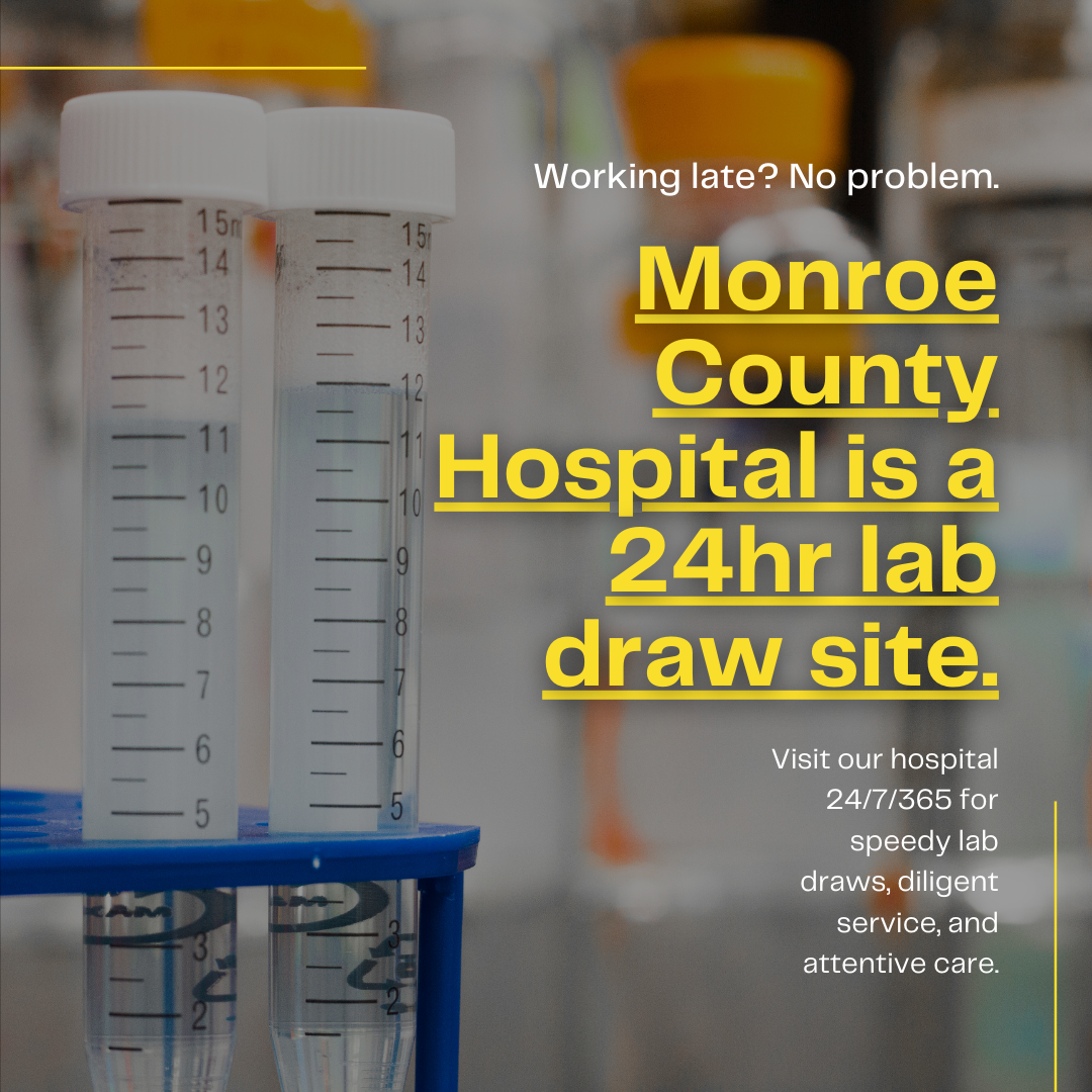 Monroe County Hospital 24-hour lab draw site sign with specimen tubes in the foreground