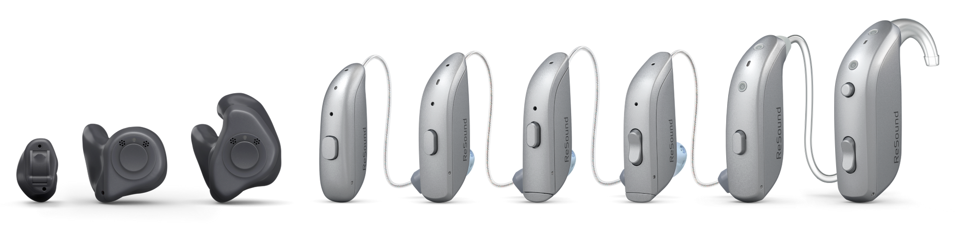 Row of various hearing aids, ranging from in-ear to behind-the-ear styles, on a white background.