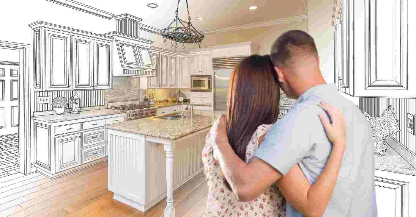 Couple embracing in a bright, modern kitchen with white cabinets and an island.