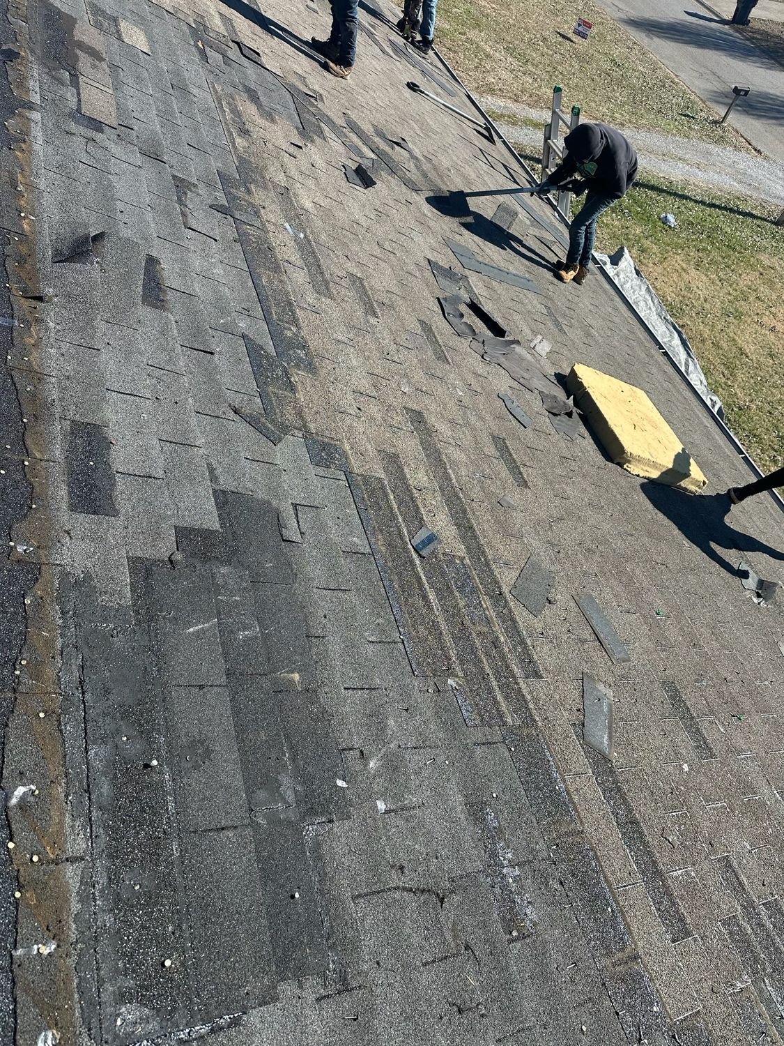 A group of people are working on a roof.