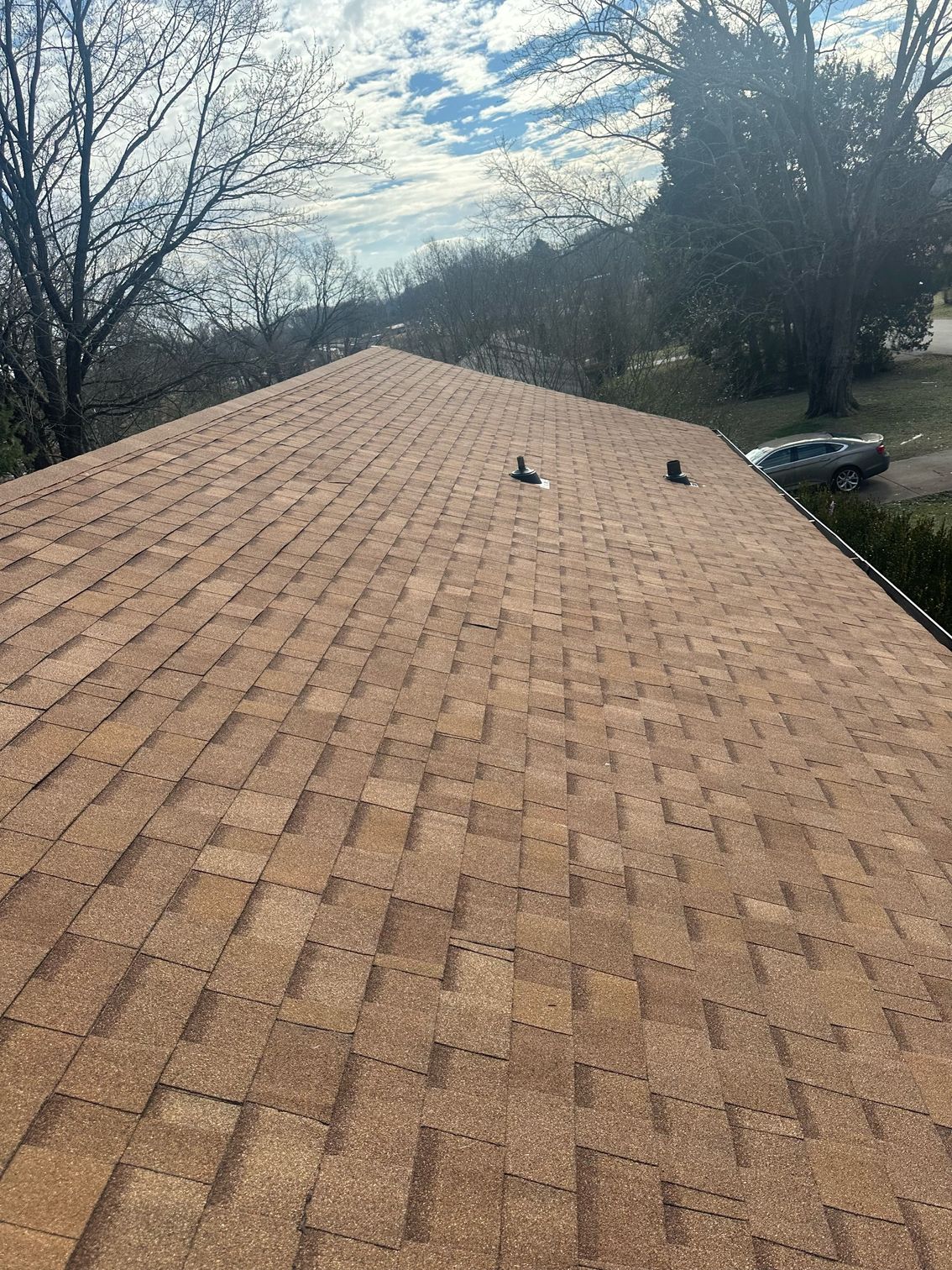 A close up of a roof with a lot of shingles on it.
