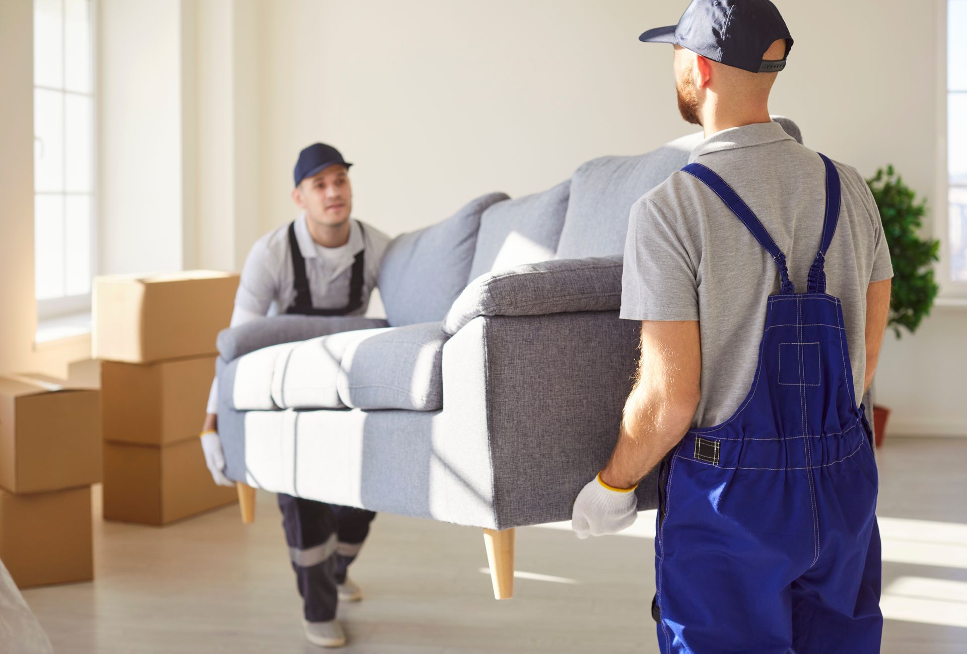 Professional movers loading boxes into a moving truck.
