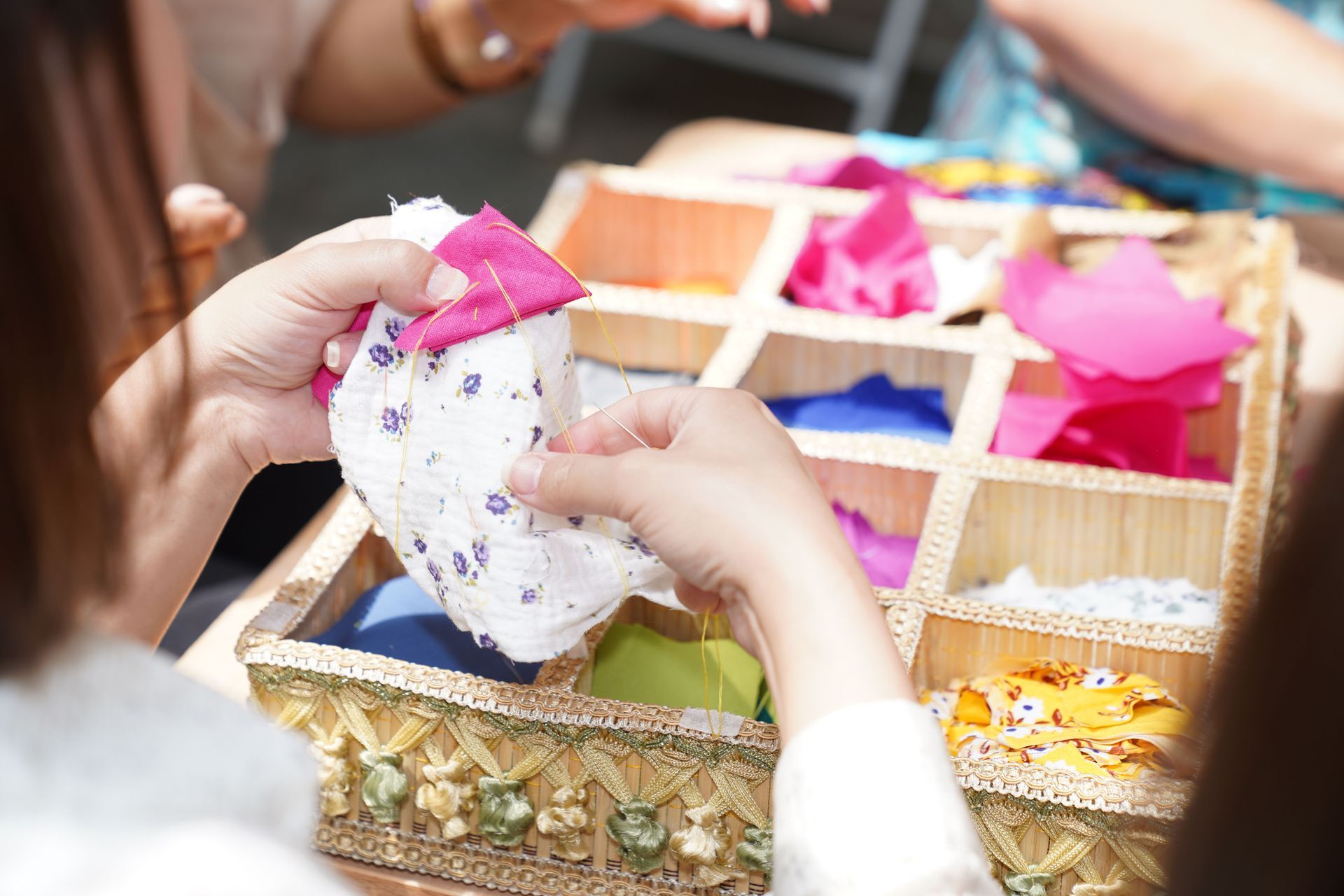Children hand stitching fabric.
