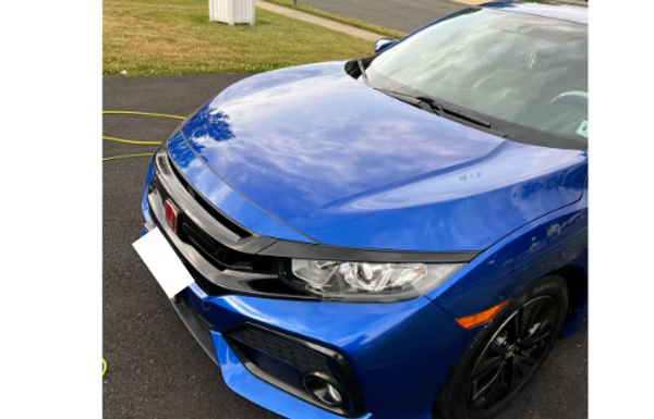 Blue Honda sedan parked outdoors on a driveway, front view with black trim and red Honda badge