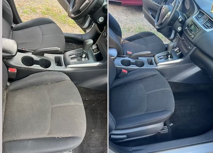 Car interior with two front seats and center console, shown in gray and black upholstery side by side