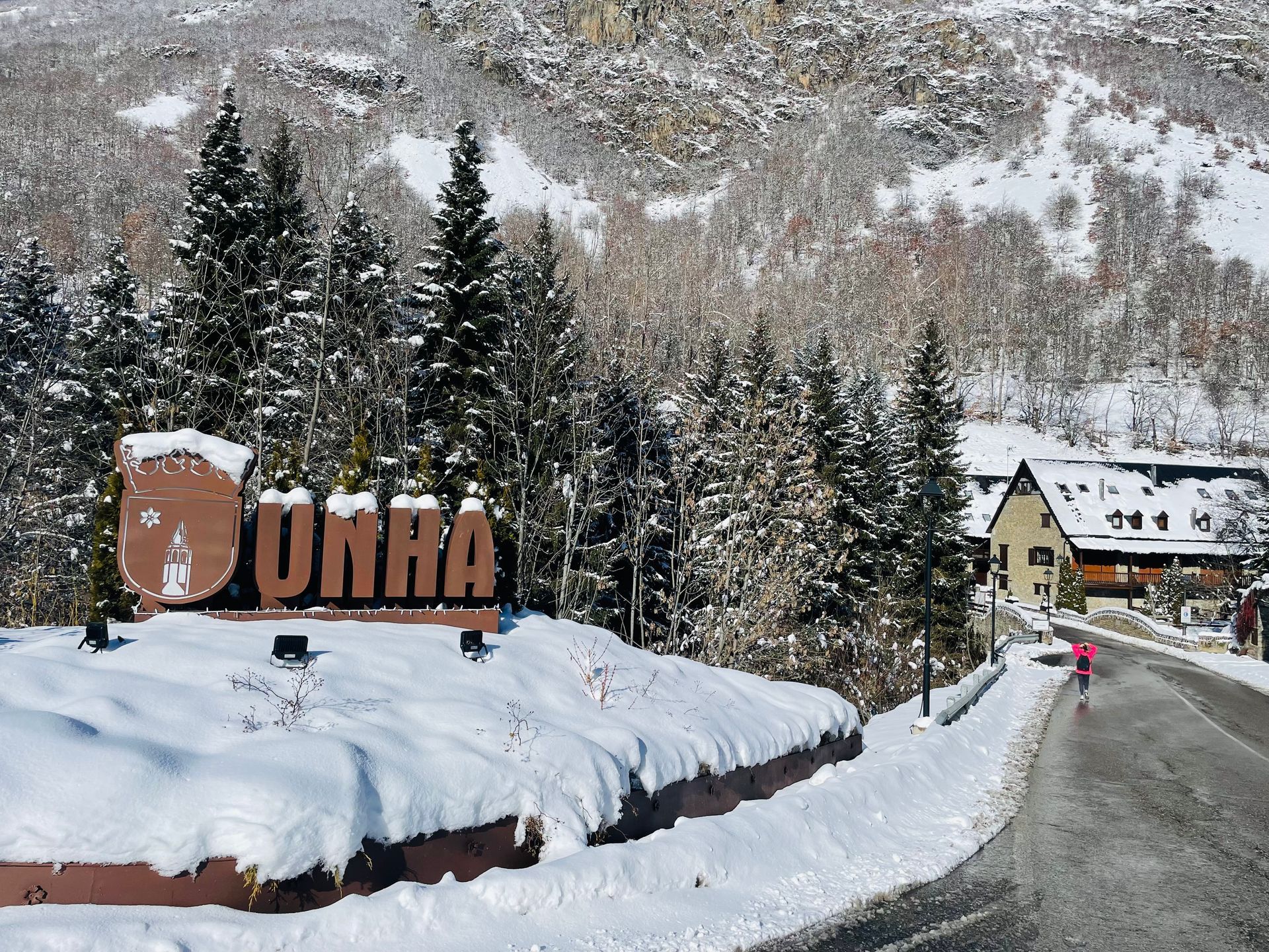 Un cartel que dice que Dunha está rodeada de nieve y árboles.