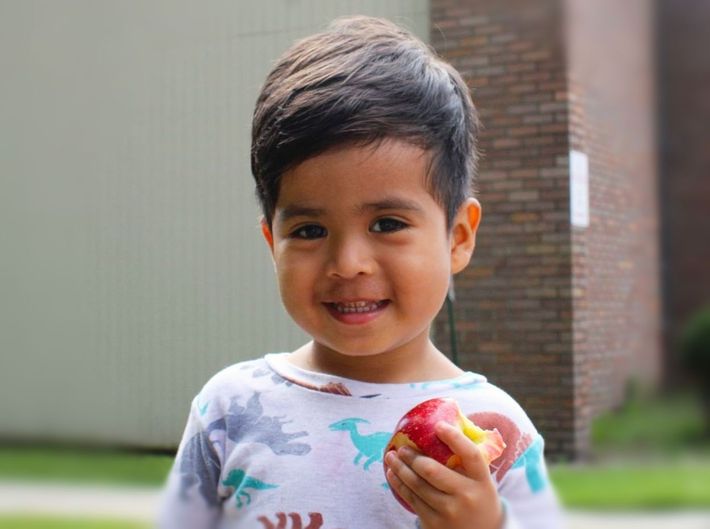 A young boy enjoys an apple at one of LCD's many Food From the Heart events.