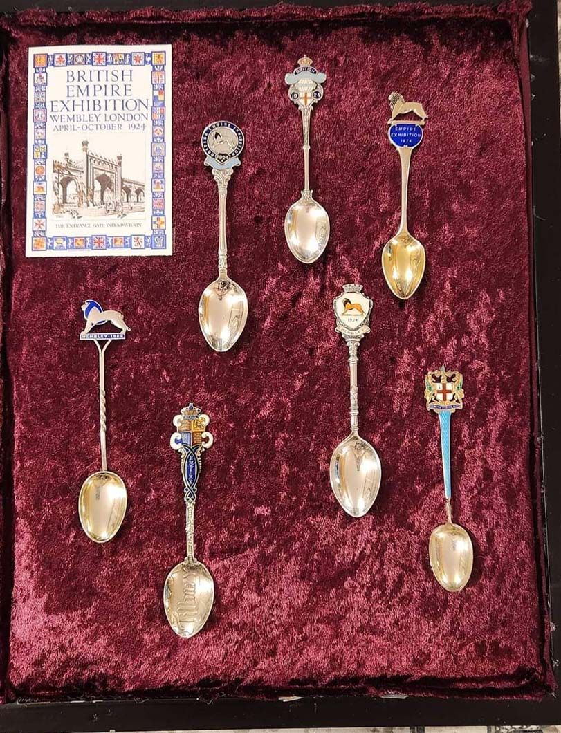 Display case with seven silver spoons. 