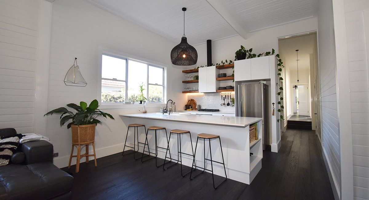 A kitchen with a large island and stools