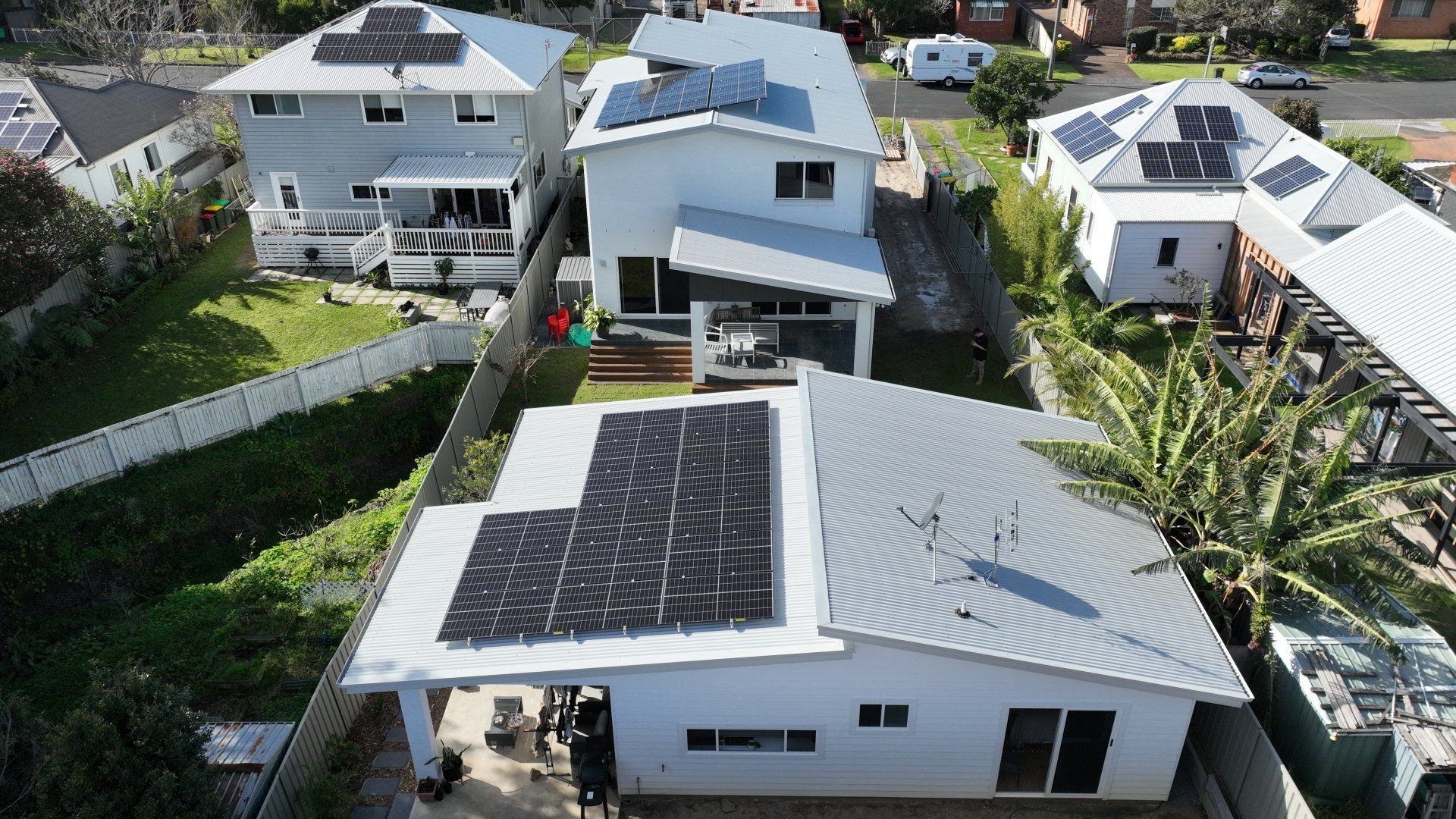 An aerial view of a house with solar panels on the roof