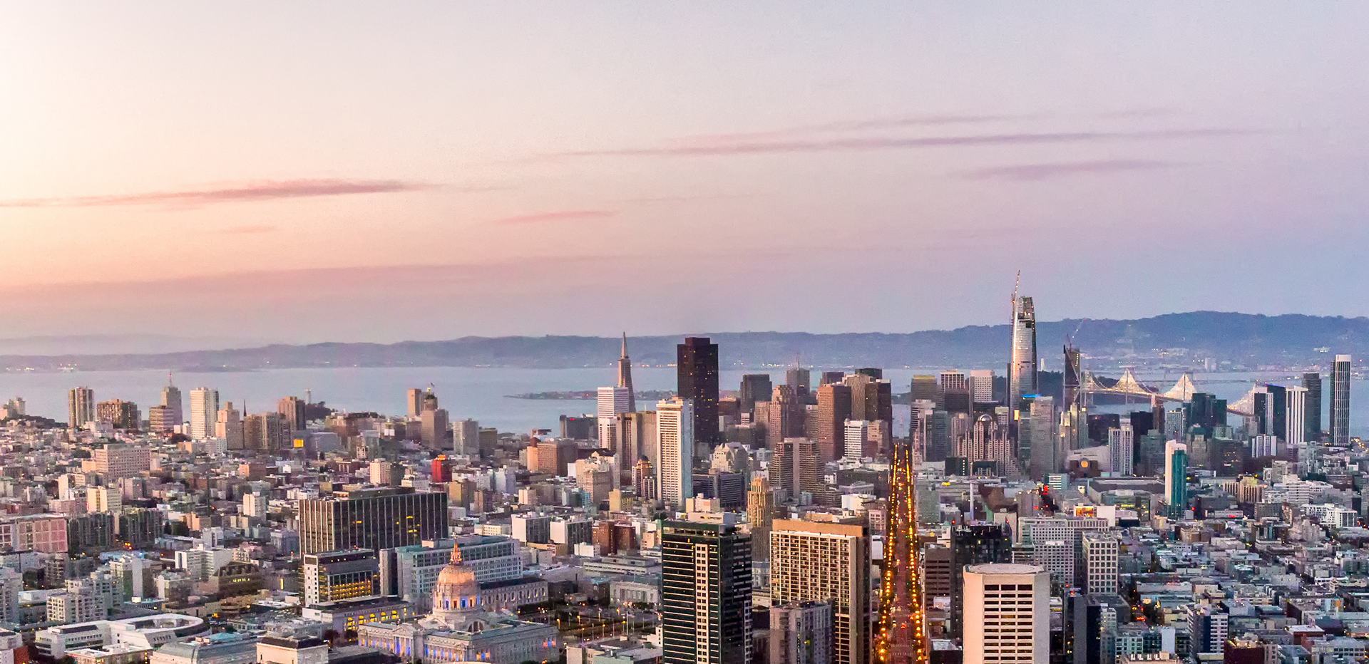 An aerial view of the city skyline at sunset.