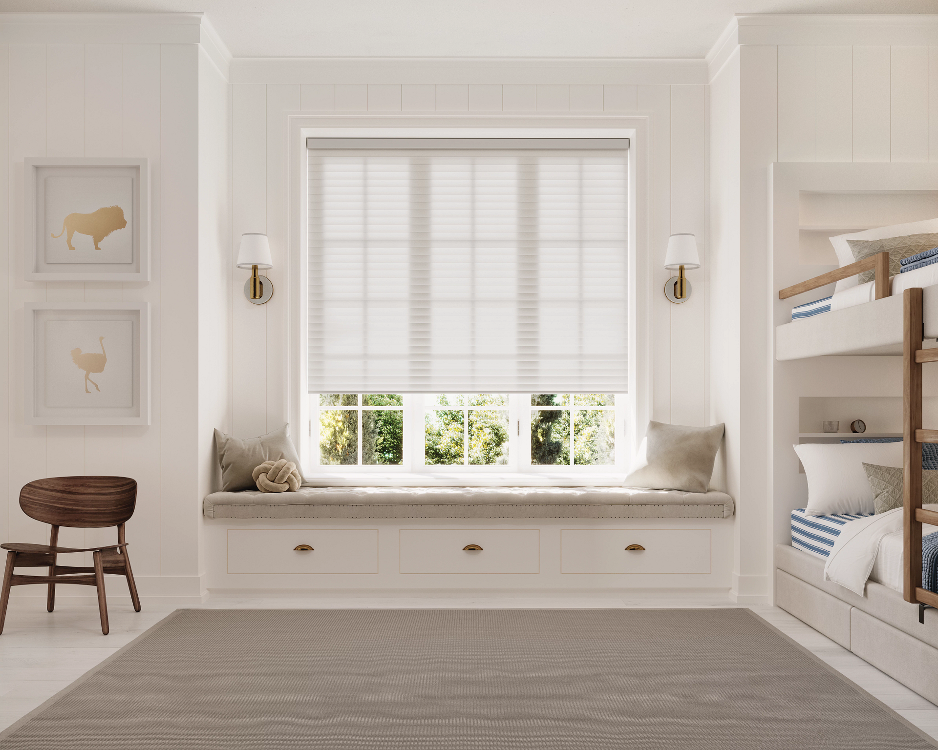 A bright room with a white window seat, pleated shades, two wall sconces, wall art, a wooden chair, and a bunk bed.