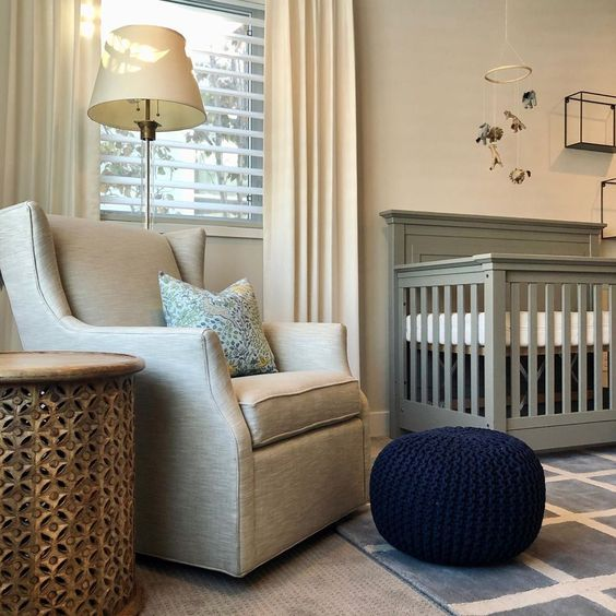 Chic nursery with soft yellow drapes, crib, and nursery chair.
