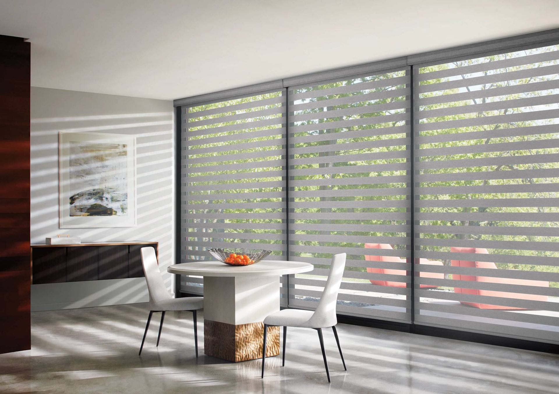 Cordless Hunter Douglas Banded Shades covering the windows of a dining area.