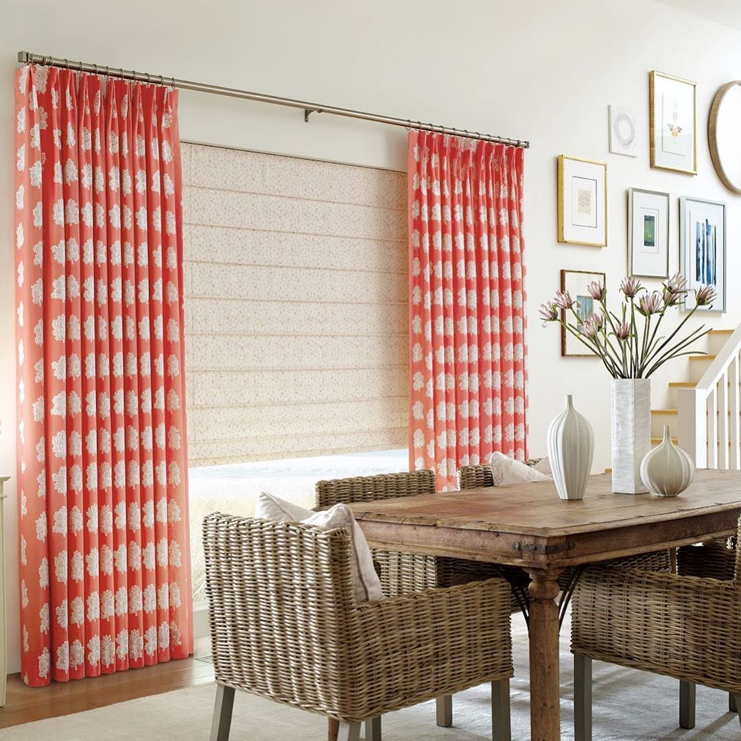Modern rustic dining area with pattered fabric drapery and Hunter Douglas Modern Vignette® Roman Shades.