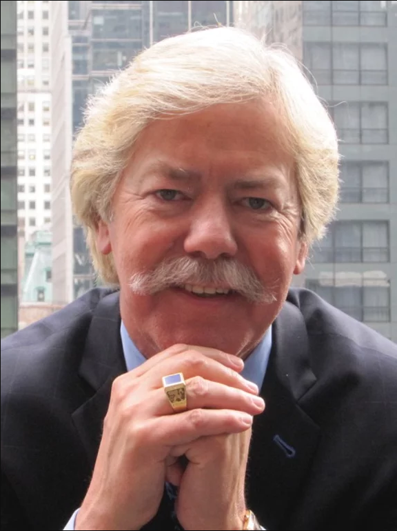 A man with a mustache and a ring on his finger