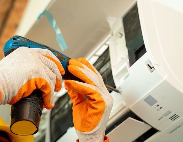 Worker Repairing Air Conditioner — Honolulu, HI — Air Conditioning Experts Worker Repairing Air Conditioner — Honolulu, HI — Air Conditioning Experts