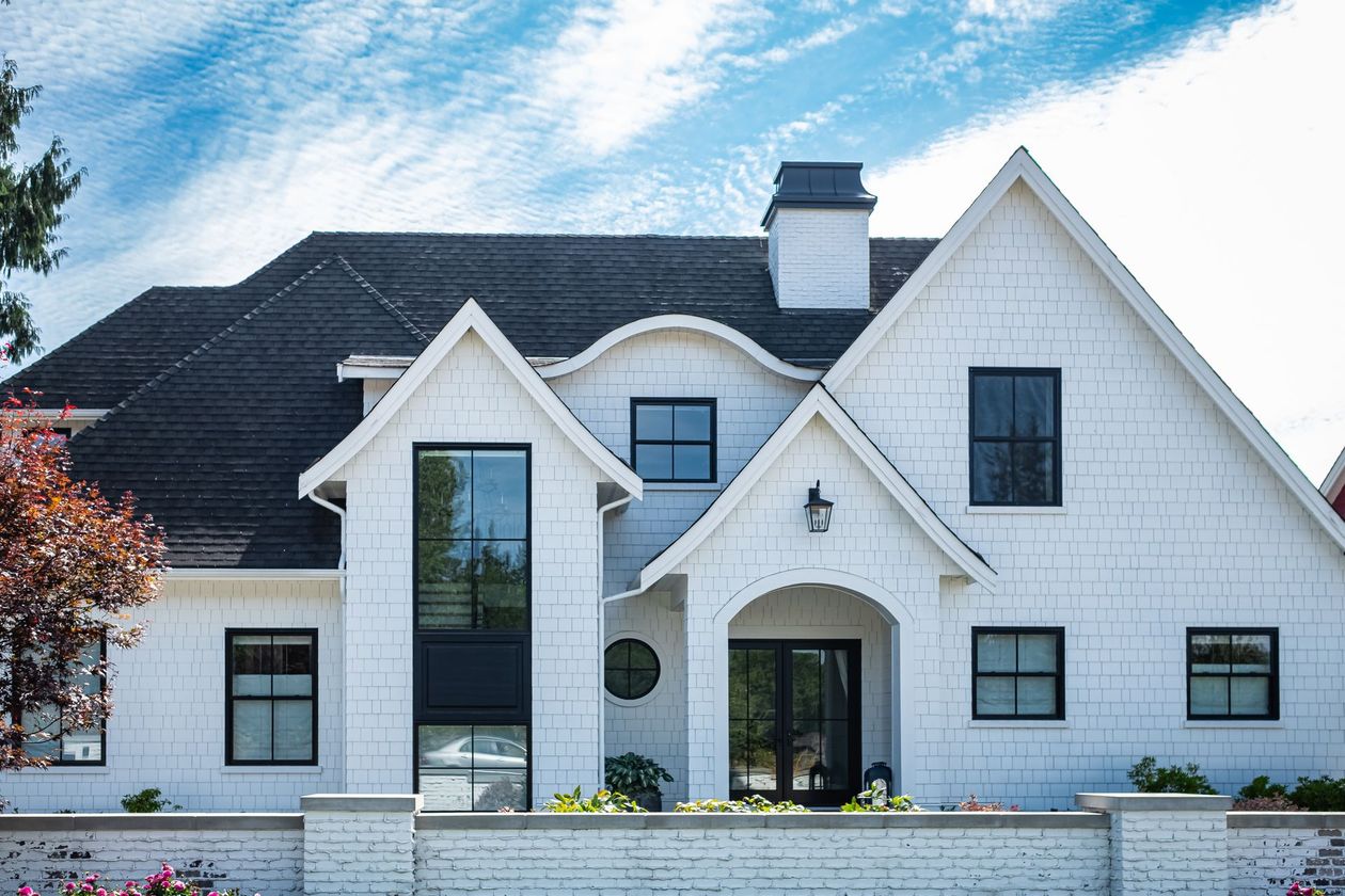 A group of people are standing in a room looking at a house.