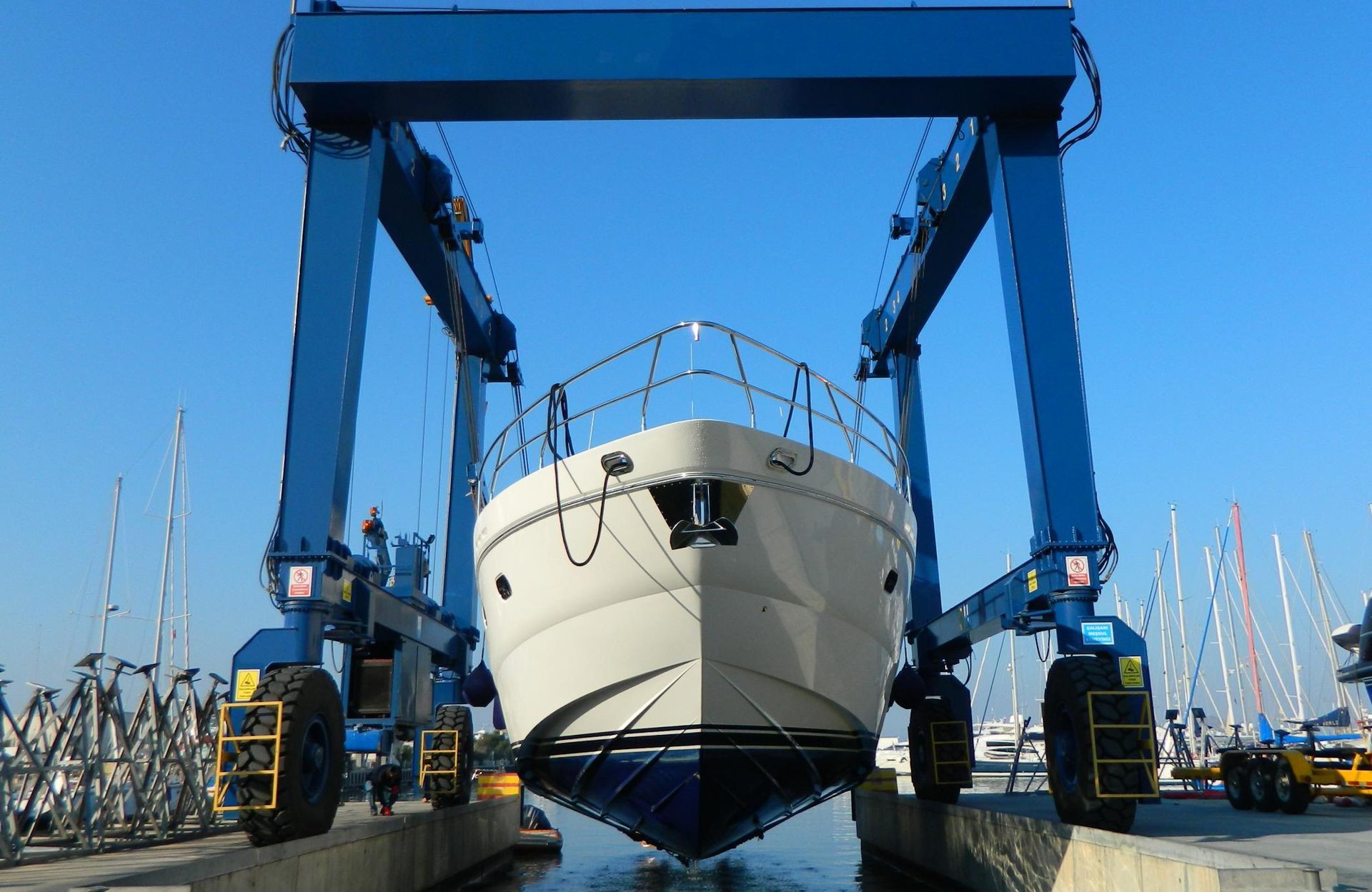 A boat is being lifted into the water by a crane.