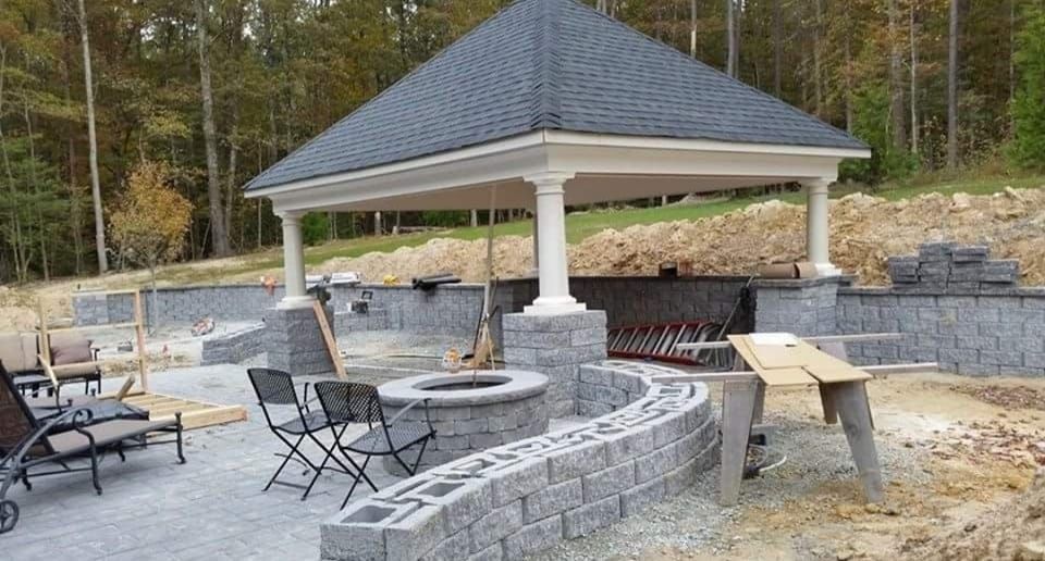 A gazebo is being built in the backyard of a house.
